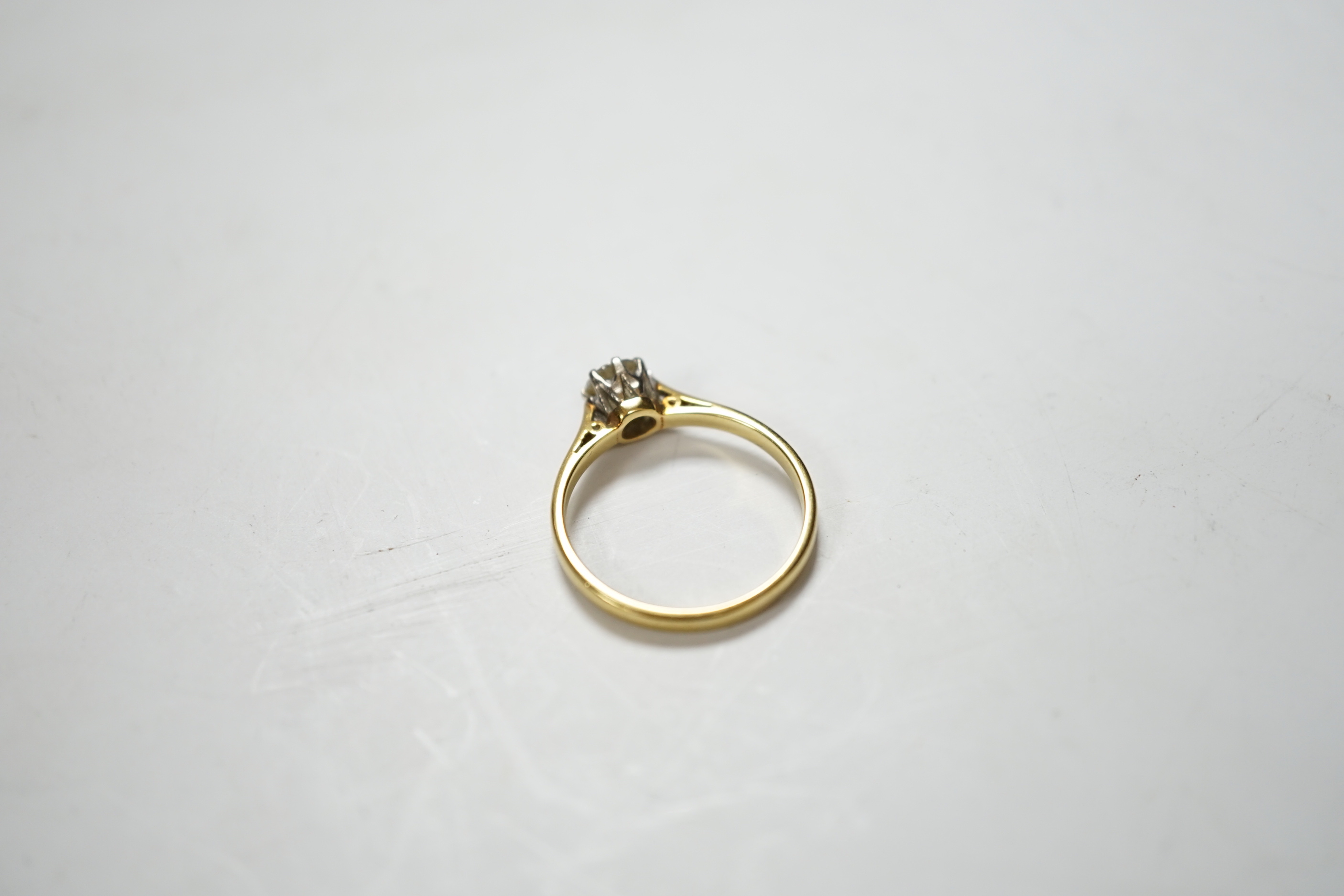 A modern 18ct gold and solitaire diamond ring, the stone measuring 5.2mm in diameter, size O/P, gross weight 2.9 grams.